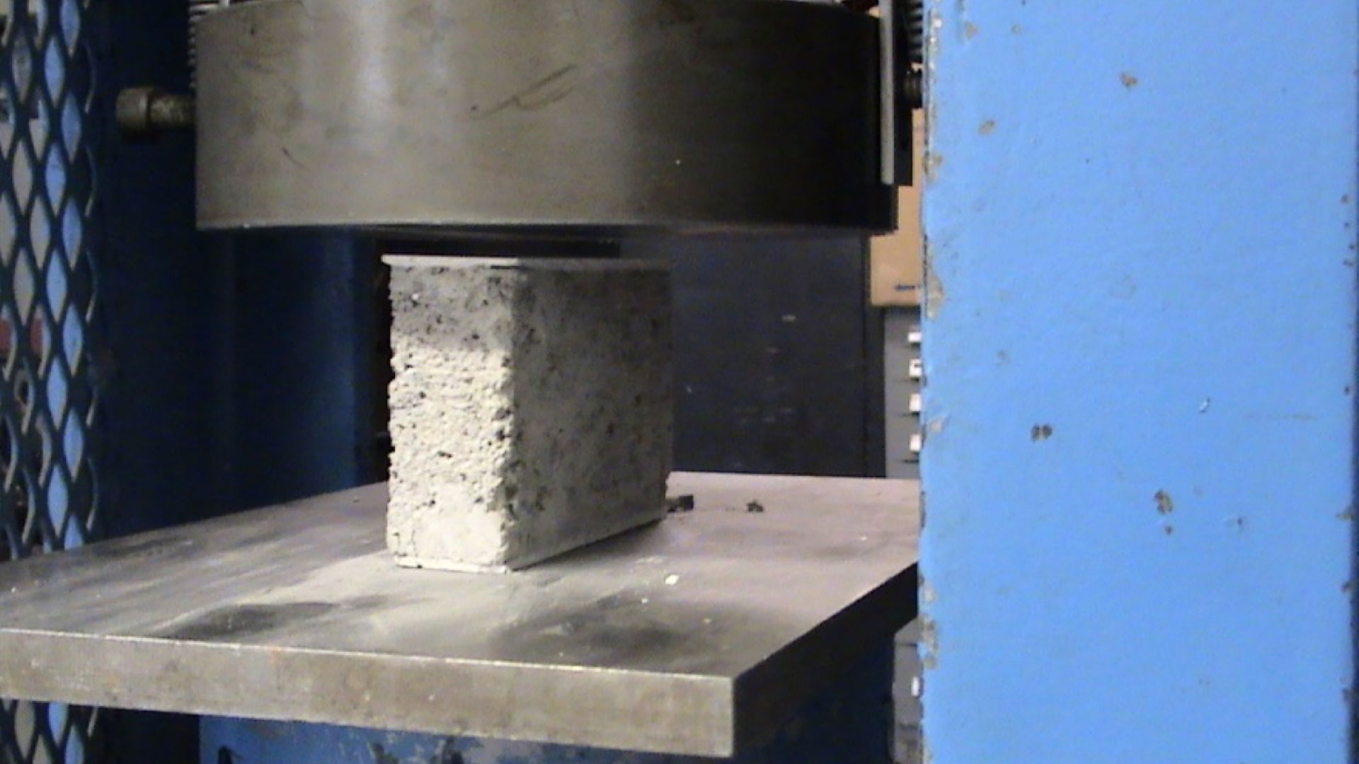 Figure 1. Laboratory compressive strength testing of a concrete block coupon. Figure 1. Laboratory compressive strength testing of a concrete block coupon.